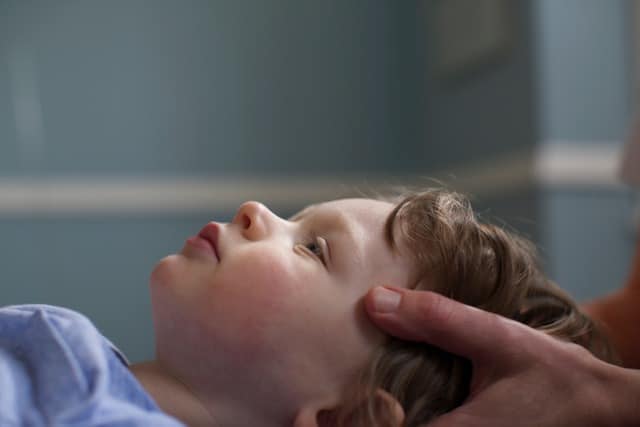 Child having cranial osteopathy