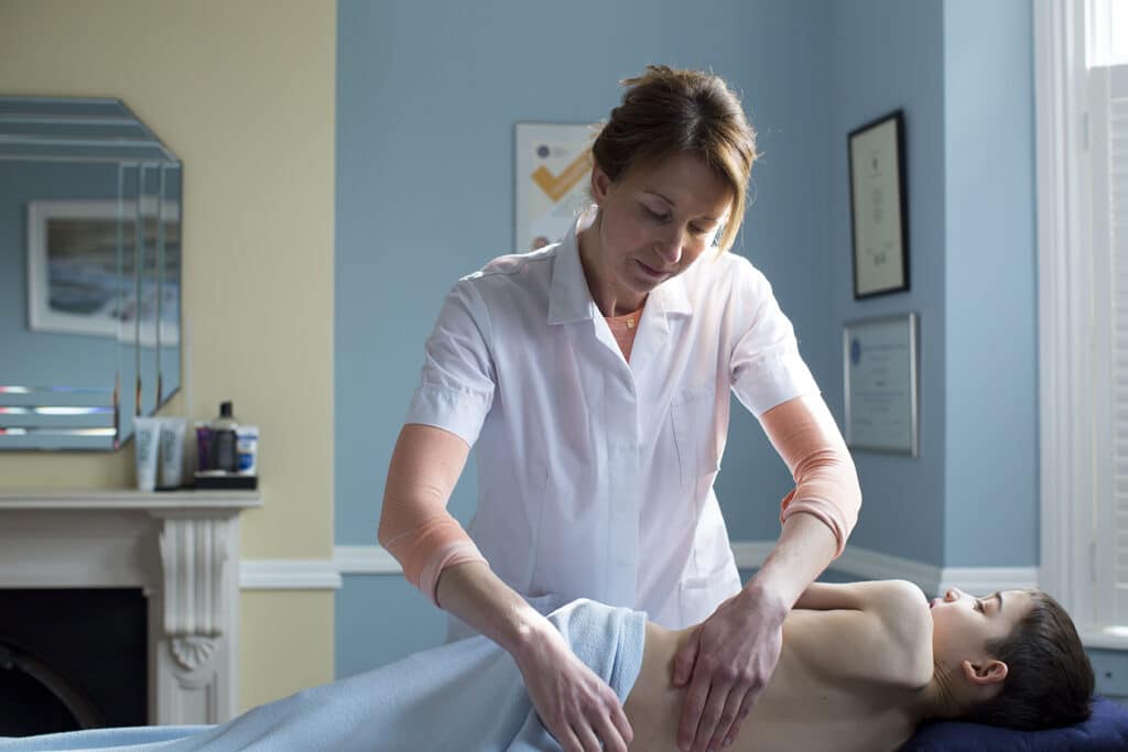 Emily Nathan practicing osteopathy with a patient